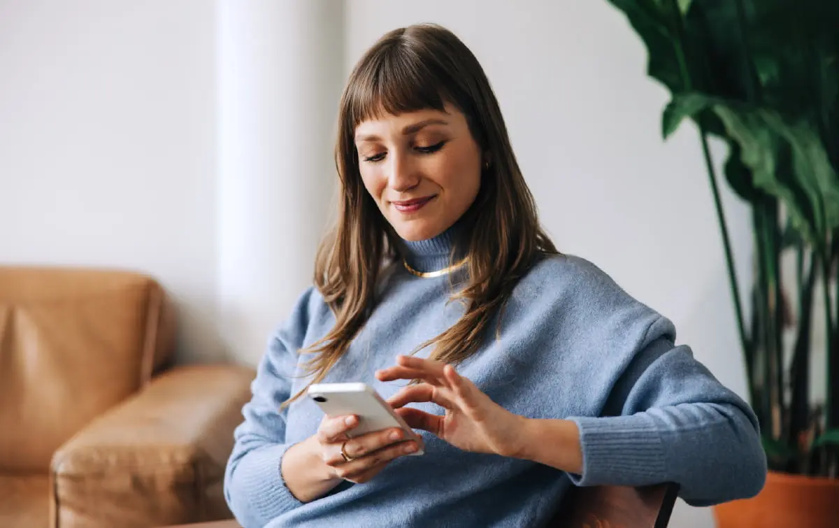 Person using a smartphone to access information, representing simple, user-friendly access to enterprise data